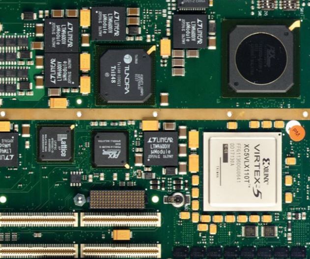 Technician inspecting assembled PCB